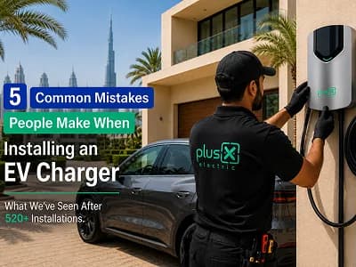 PlusX Electric technician installing a home EV charger on a villa wall in the UAE